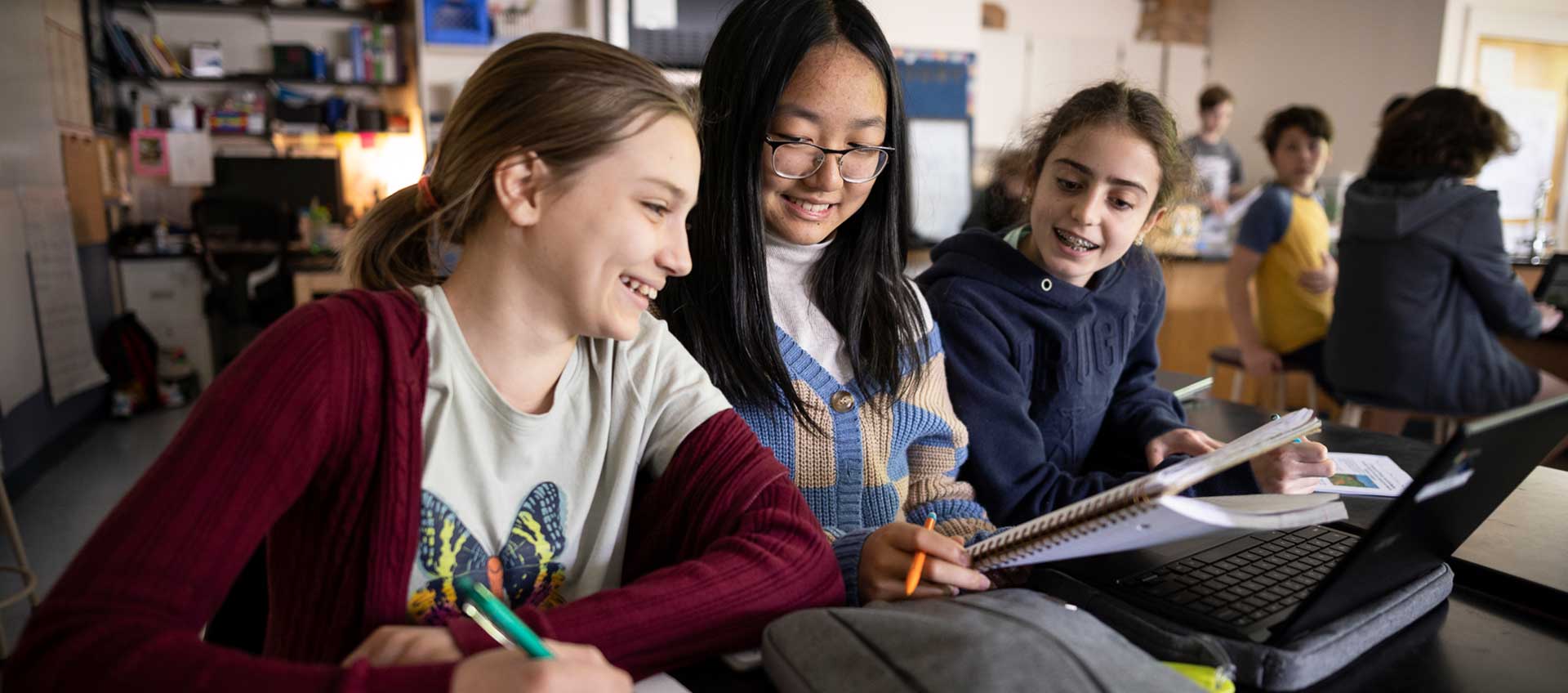 Three students complete a lab report